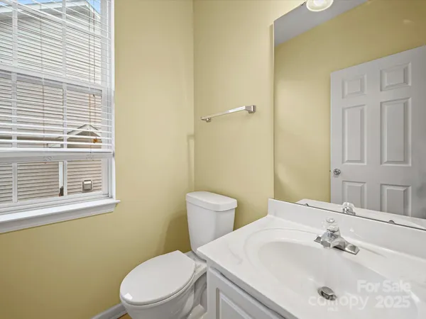 a bathroom with a sink a toilet and mirror