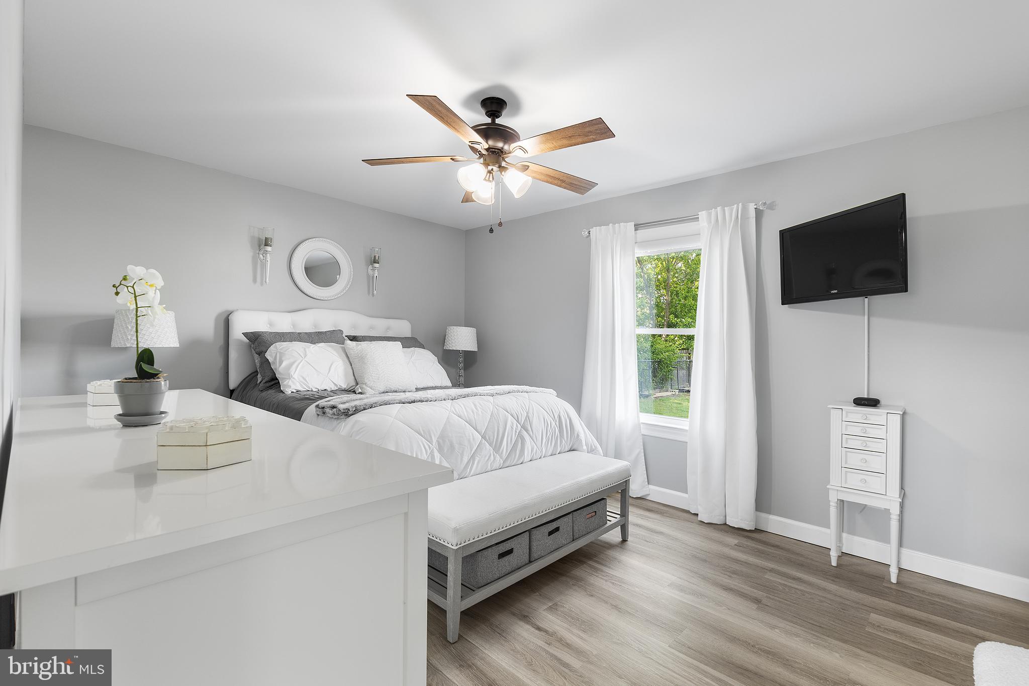 25485 Hignutt Road Denton, MD 21629 - Photo 21 of 52 a bedroom with a bed and a flat screen tv