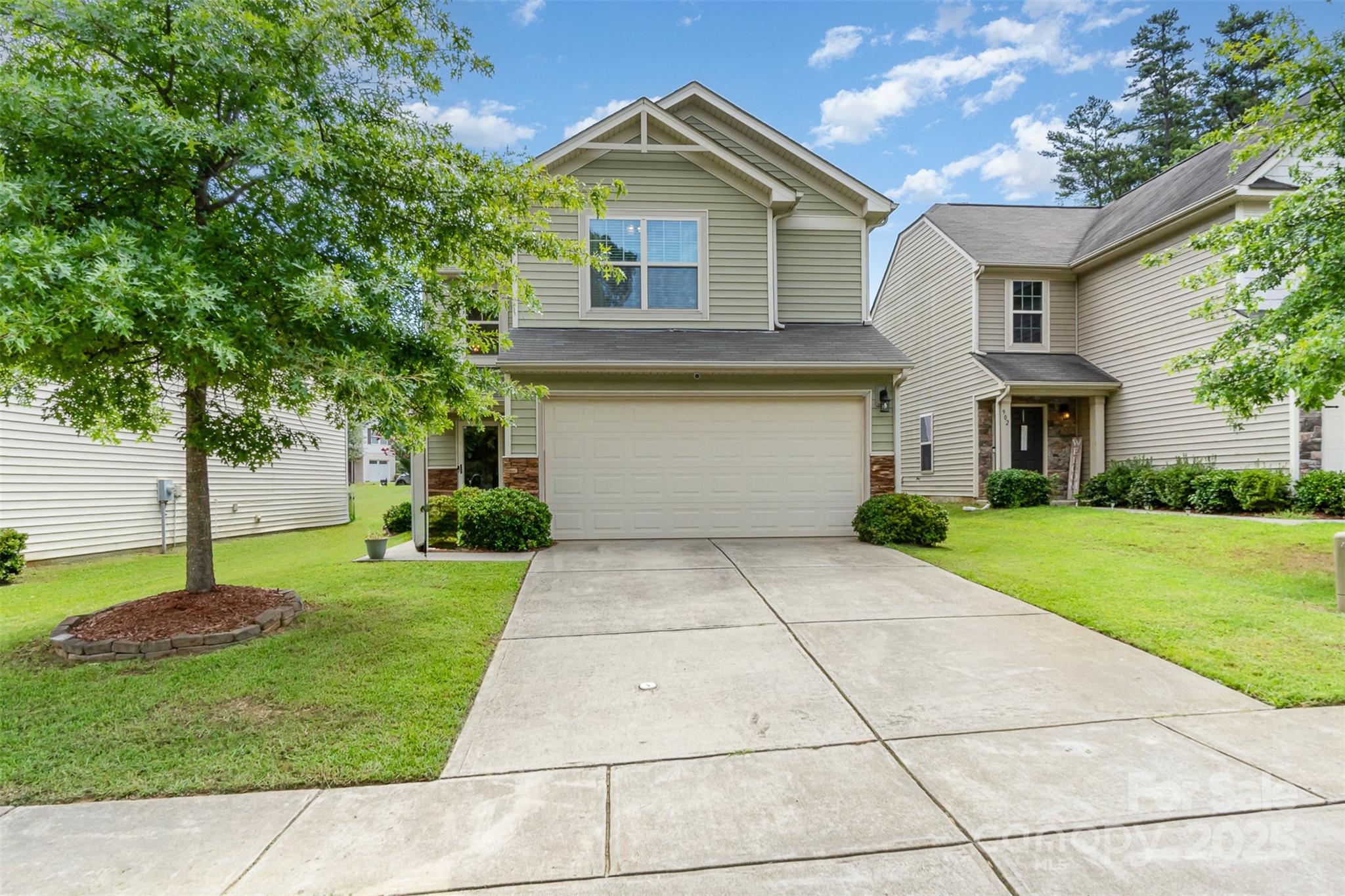 906 Rook Road Charlotte, NC 28216 - Photo 1 of 25 a front view of a house with garden