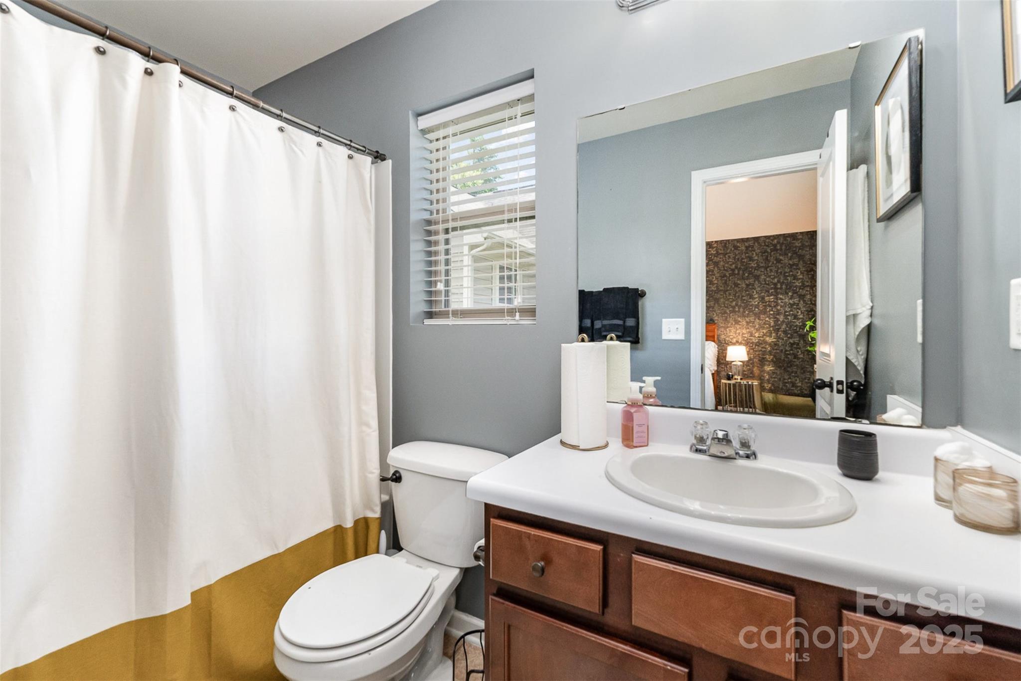 906 Rook Road Charlotte, NC 28216 - Photo 15 of 25 a bathroom with a granite countertop sink toilet and mirror