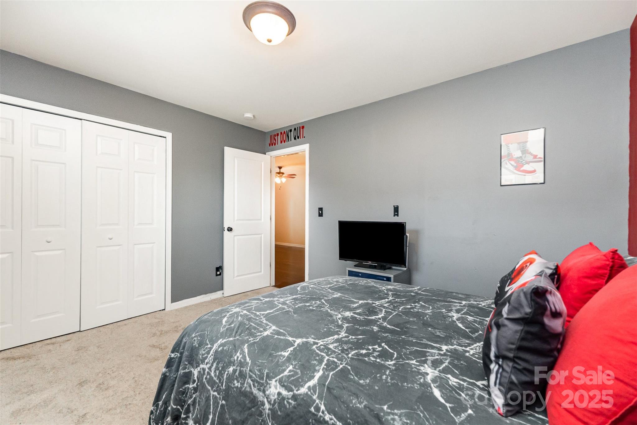 906 Rook Road Charlotte, NC 28216 - Photo 16 of 25 a bedroom with a bed and a flat screen tv