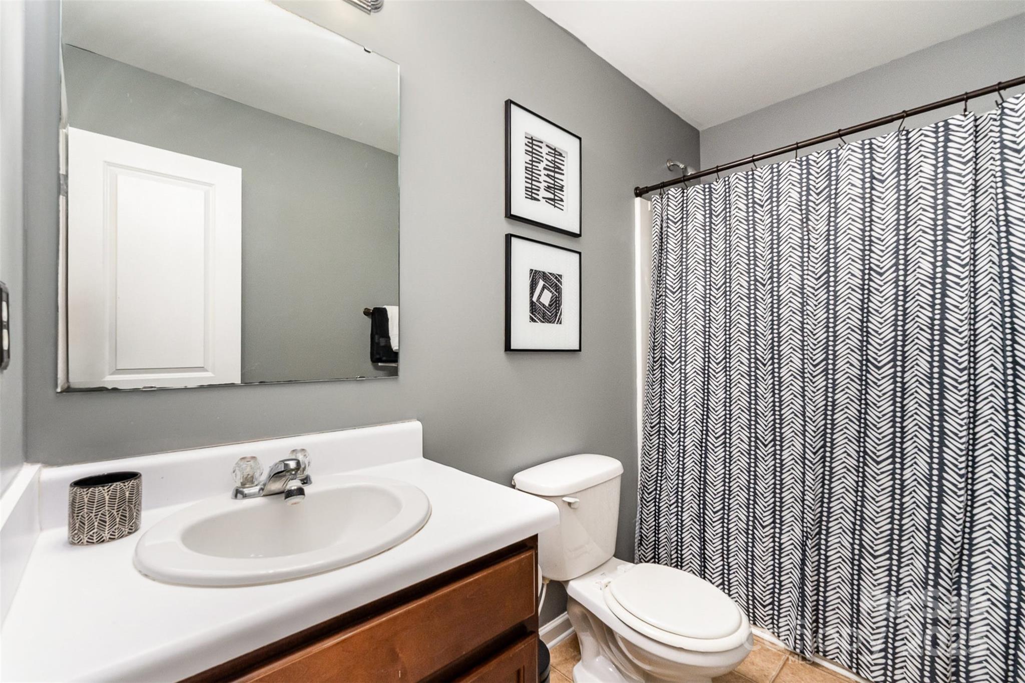 906 Rook Road Charlotte, NC 28216 - Photo 20 of 25 a bathroom with a sink a toilet and shower curtain