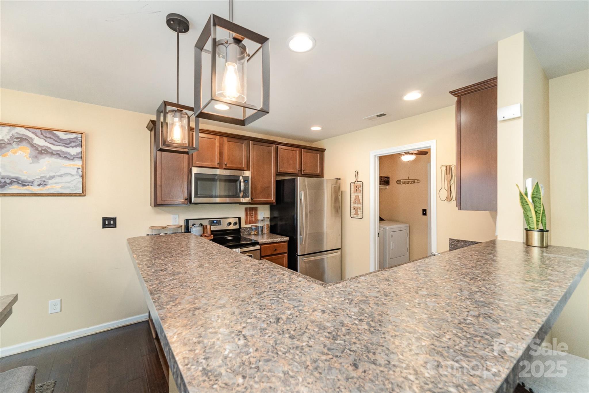906 Rook Road Charlotte, NC 28216 - Photo 10 of 25 a view of a kitchen with stainless steel appliances kitchen island granite countertop a refrigerator and a sink