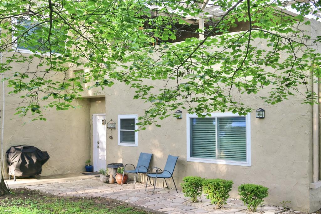 a backyard of a house with table and chairs
