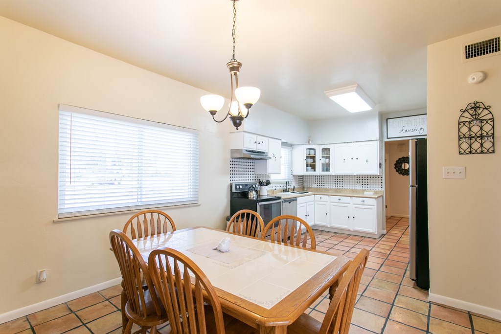 541 D Sand Bend Kerrville, TX 78028 - Photo 15 of 41 a view of a dining room with furniture a chandelier and wooden floor