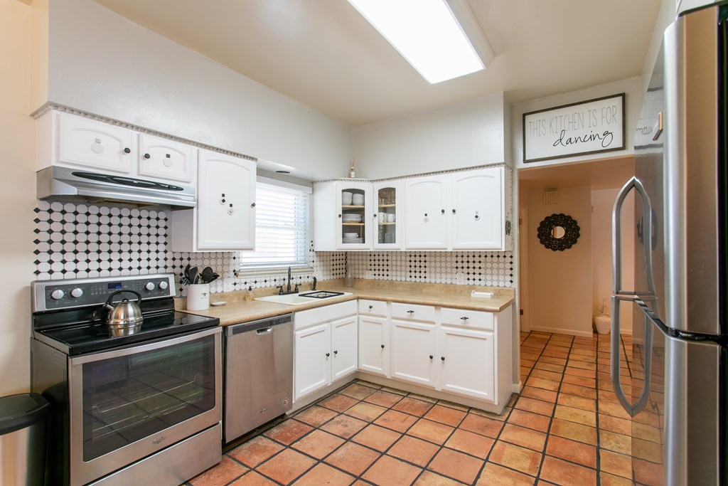 541 D Sand Bend Kerrville, TX 78028 - Photo 17 of 41 a kitchen with stainless steel appliances granite countertop a stove a sink and a refrigerator