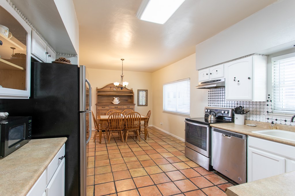 541 D Sand Bend Kerrville, TX 78028 - Photo 19 of 41 a kitchen with a sink a stove and chairs