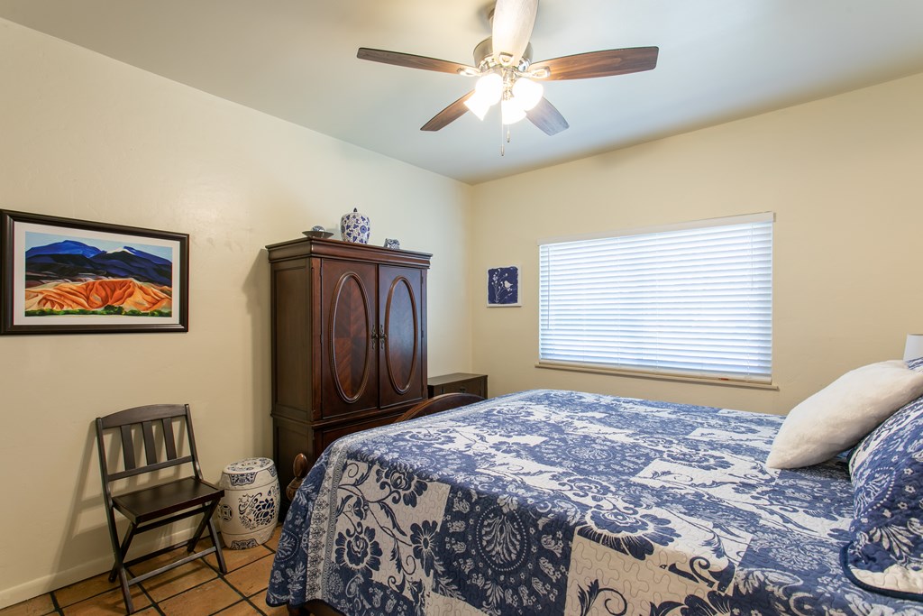 541 D Sand Bend Kerrville, TX 78028 - Photo 23 of 41 a bedroom with a bed and a chandelier