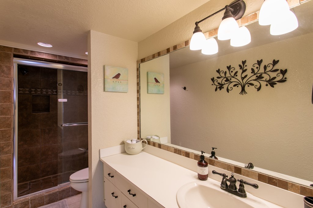 541 D Sand Bend Kerrville, TX 78028 - Photo 30 of 41 a bathroom with a sink vanity granite and a mirror