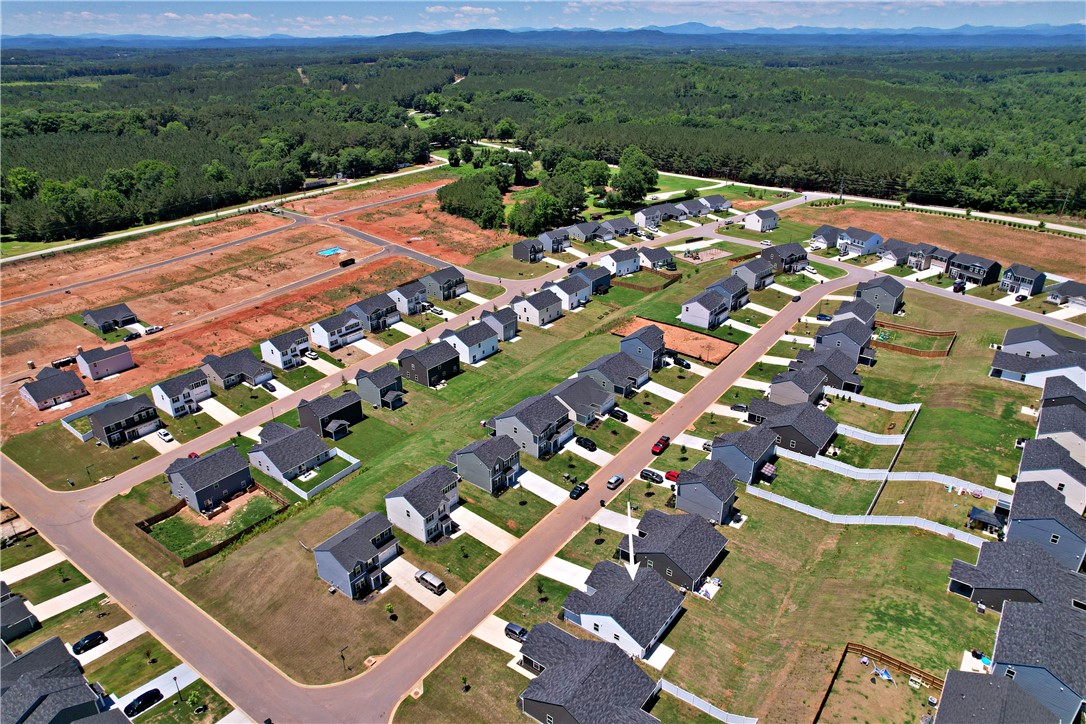 723 Peridot Way Westminster, SC 29693 - Photo 40 of 45 Discover a thriving community with diverse homes nestled against a verdant forest and distant mountains.