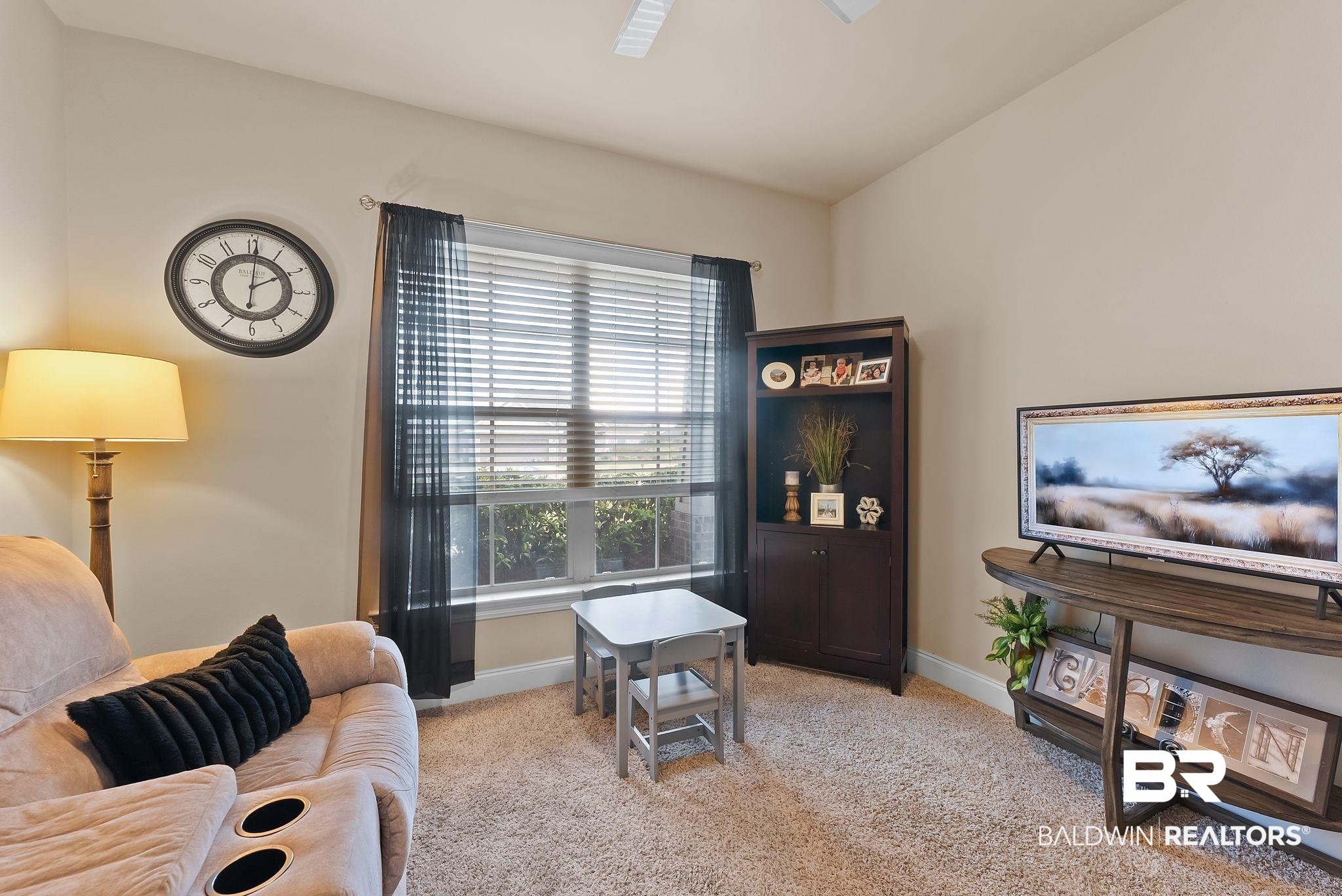 7015 Rocky Rd Loop Gulf Shores, AL 36542 - Photo 14 of 41 Living area with light carpet and a ceiling fan