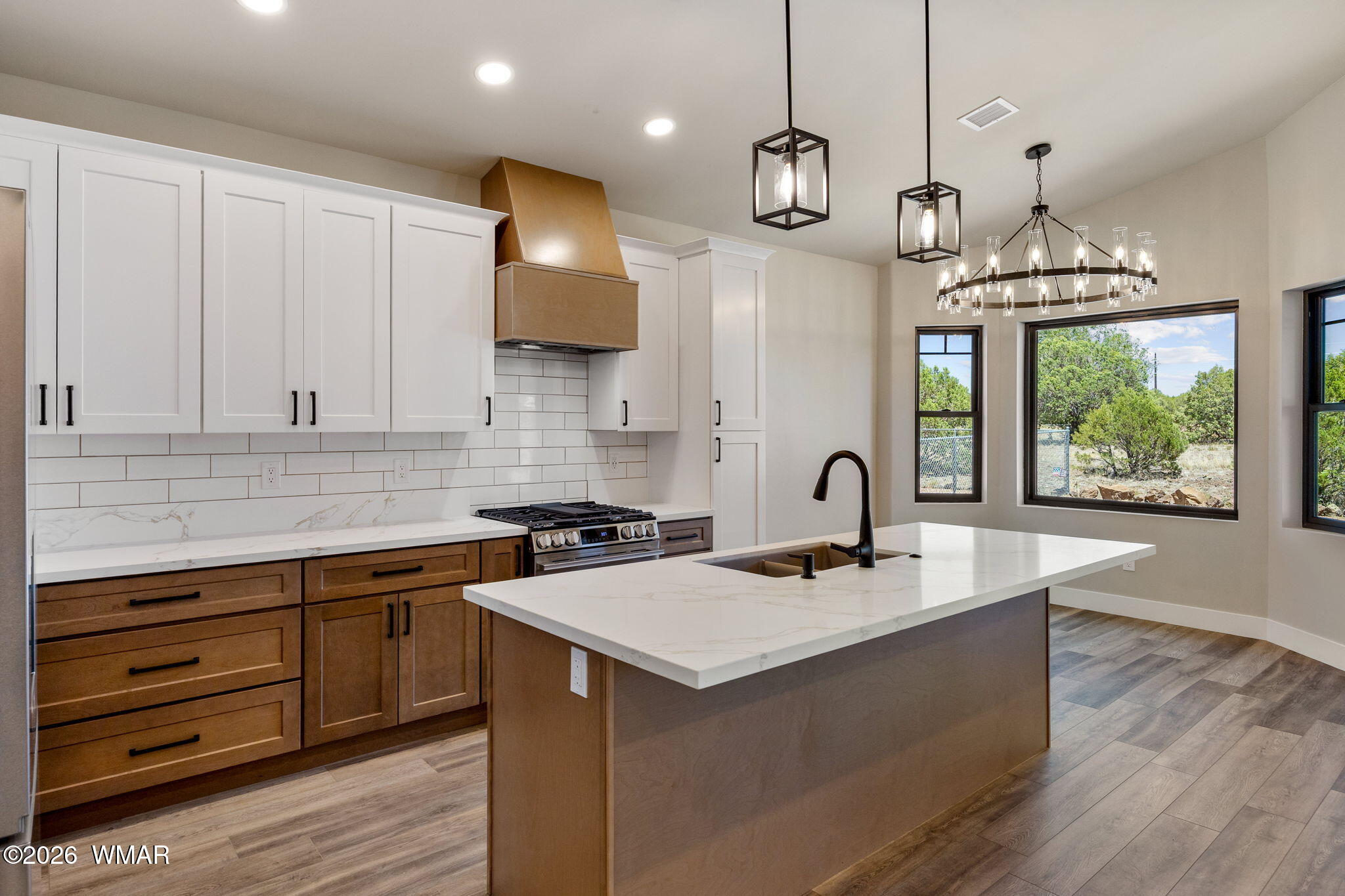 561 South Rock Ridge Drive Show Low, AZ 85901 - Photo 5 of 28 a kitchen with a sink stainless steel appliances and cabinets