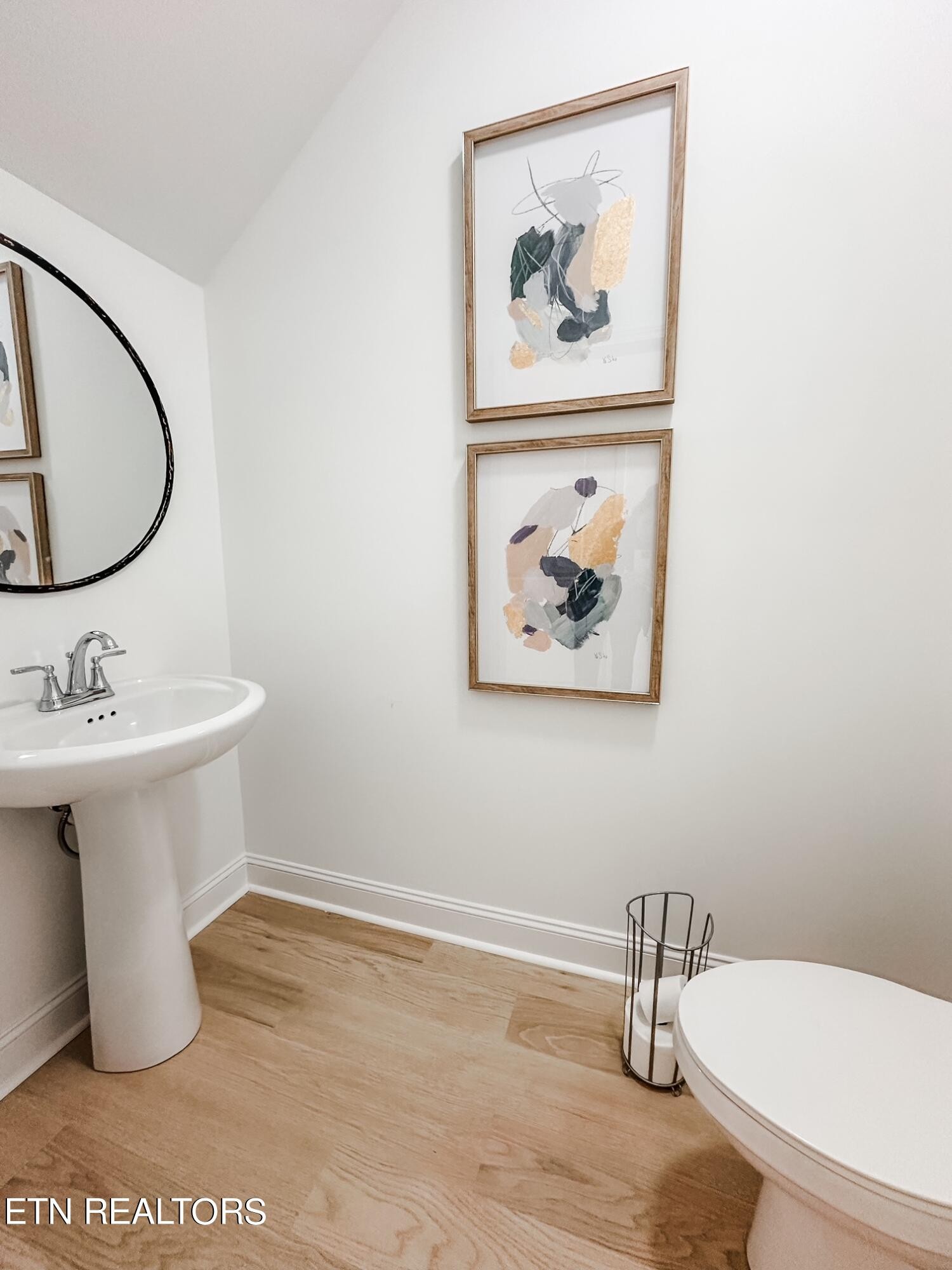 8405 Whisper Lane Powell, TN 37849 - Photo 15 of 39 a bathroom with a toilet a sink and mirror