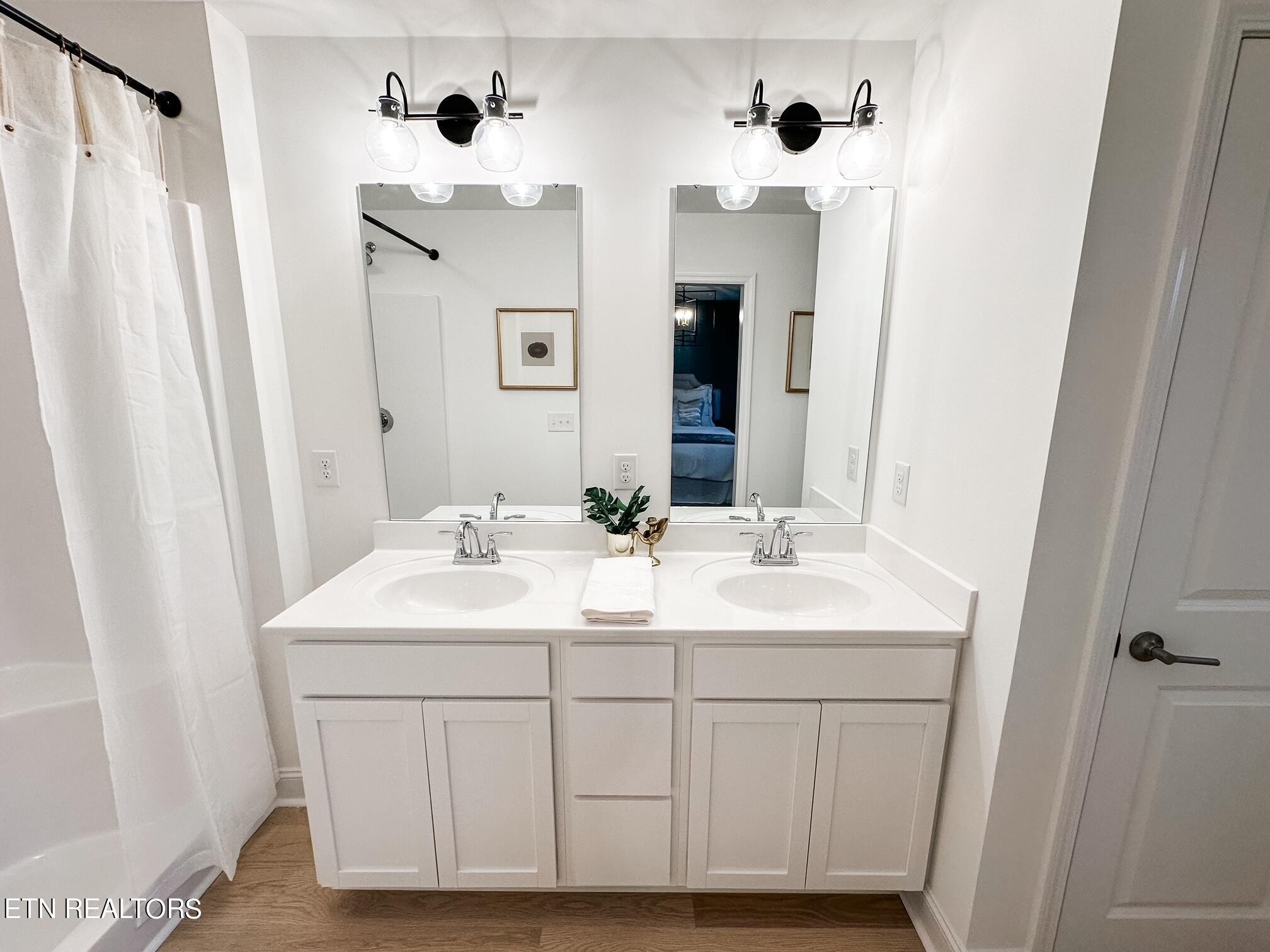 8405 Whisper Lane Powell, TN 37849 - Photo 21 of 39 a bathroom with double vanity sink and mirror