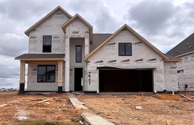a view of a house with a yard and garage