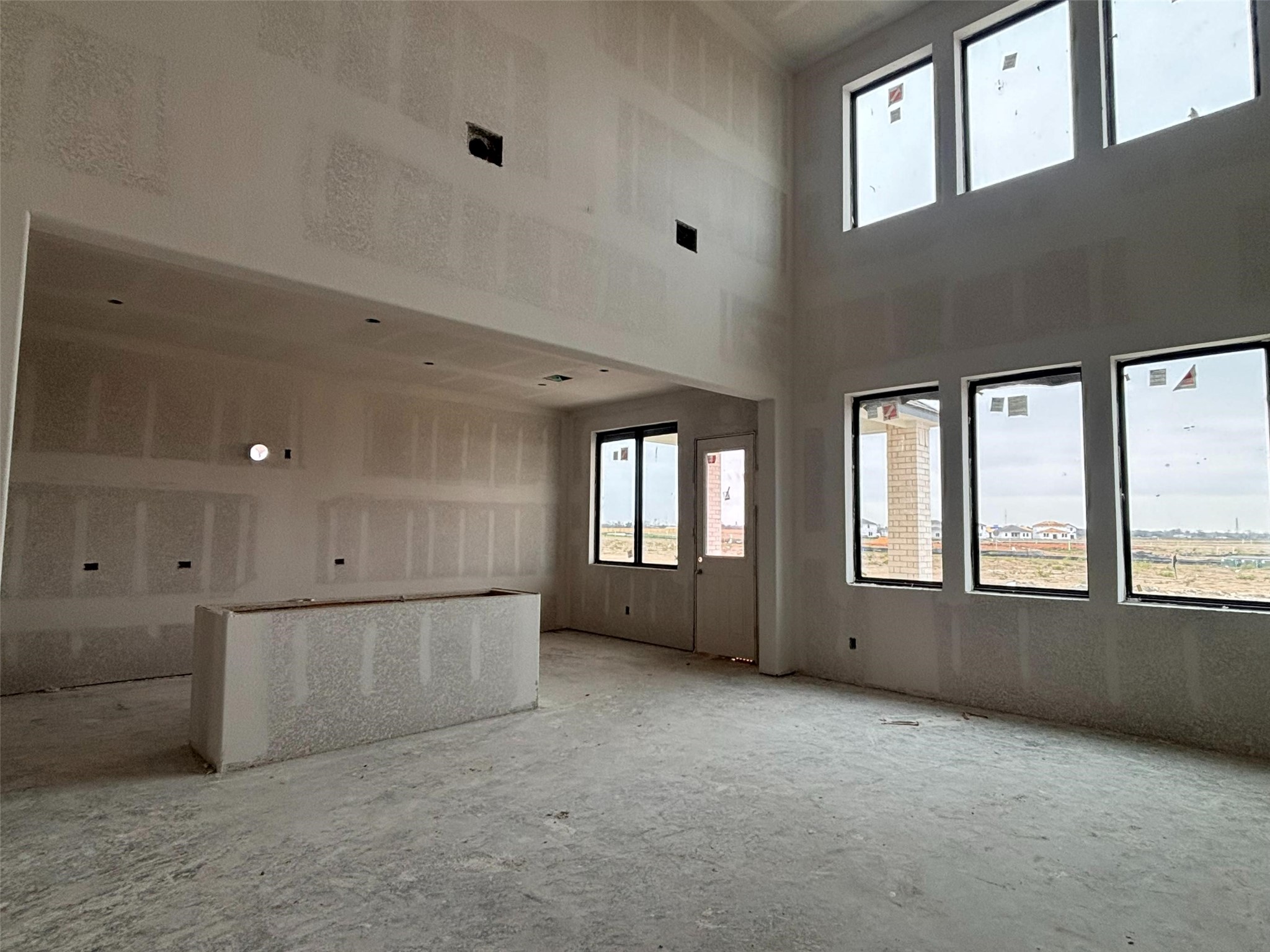 7907 Jasper Meadows Way Angleton, TX 77515 - Photo 22 of 34 an empty room with windows and pillars in it