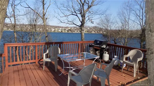 a view of balcony with wooden floor and outdoor seating