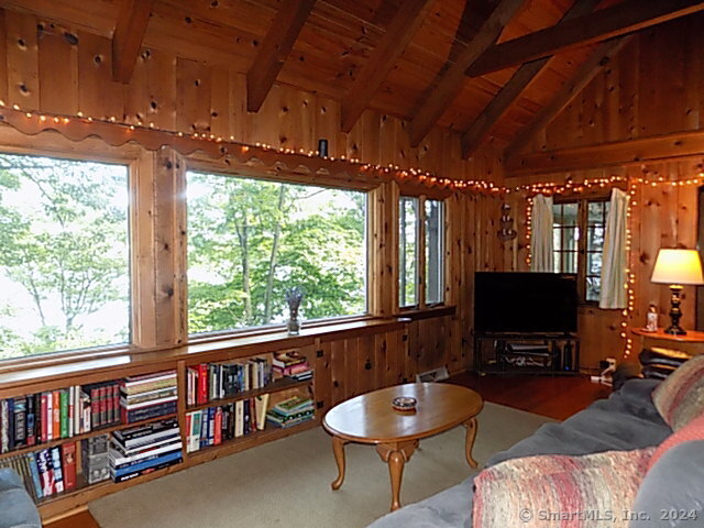 3 Partridge Lane New Fairfield, CT 06812 - Photo 12 of 26 a living room with furniture a flat screen tv and a floor to ceiling window