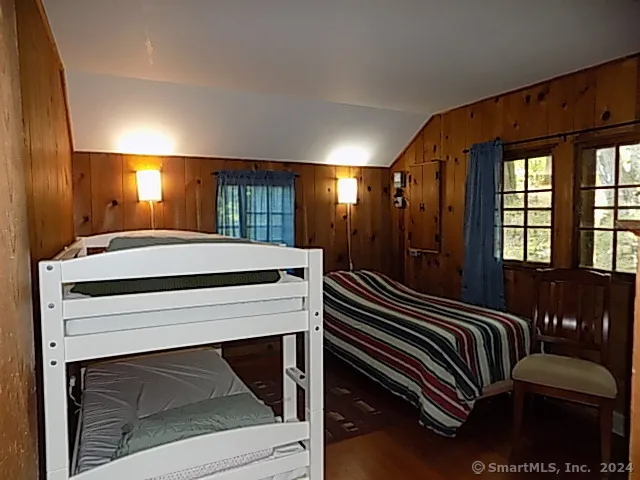 a front view of a house with swimming pool and furniture