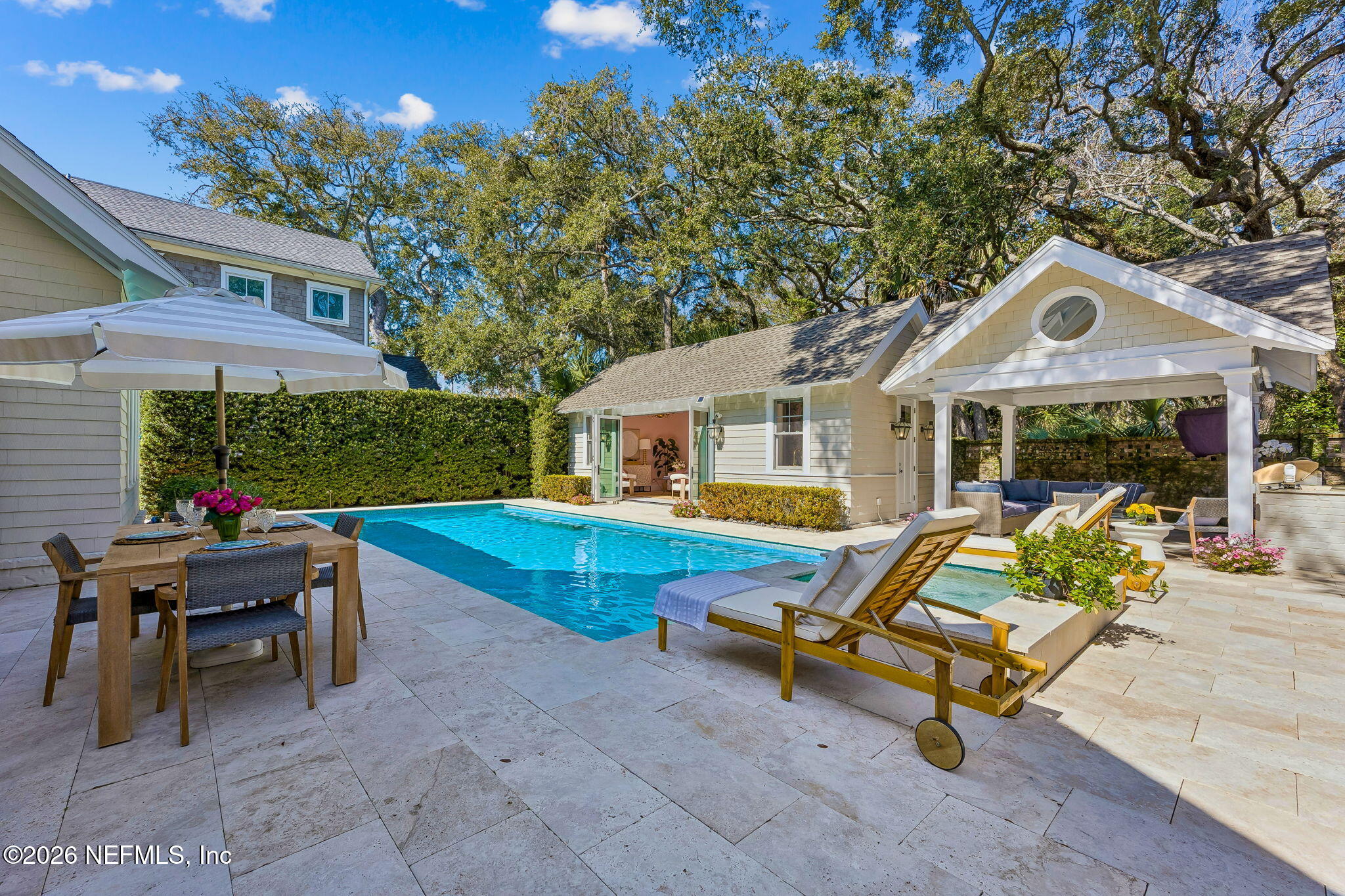 a view of a house with swimming pool and sitting area