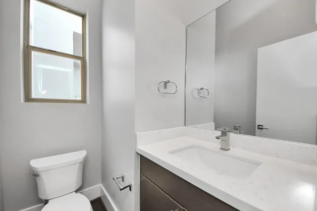 a bathroom with a sink toilet and vanity