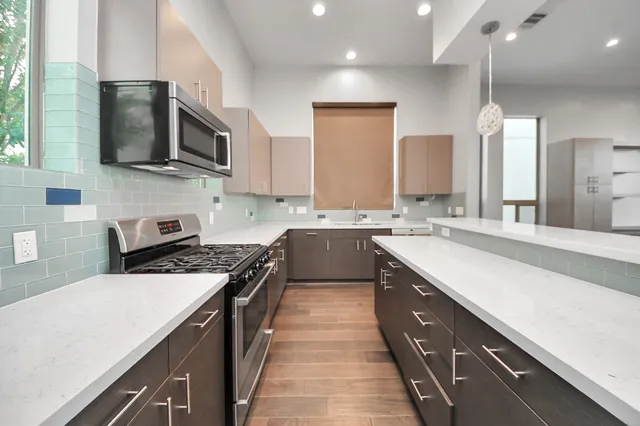 a kitchen with a sink stove and microwave