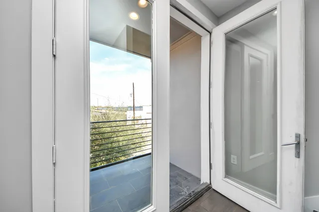 a view of a glass door and a window