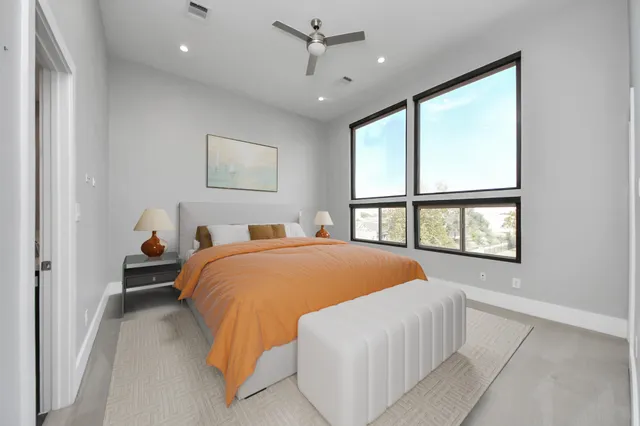 a bedroom with a large bed and a window