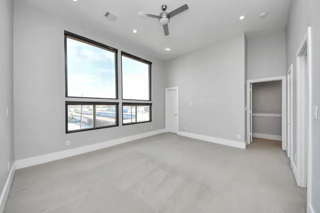 an empty room with windows and closet