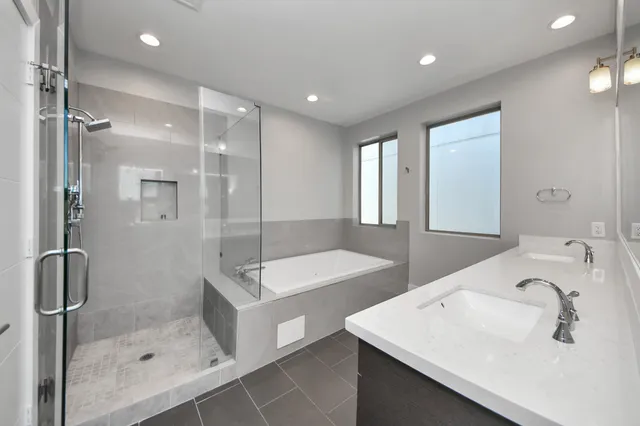 a bathroom with a shower sink and mirror