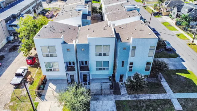 an aerial view of a house with a yard and potted plants