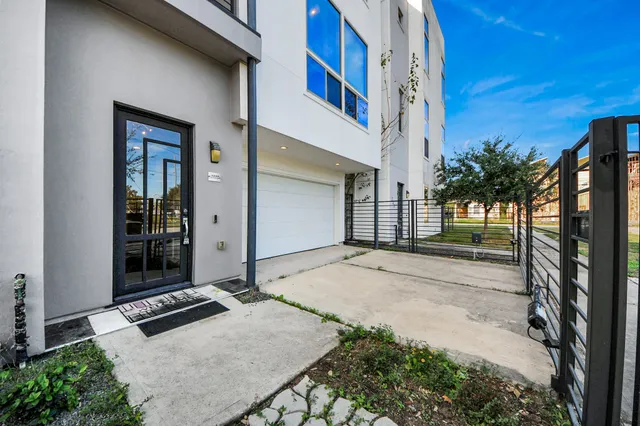 a backyard of a house with a garden and entryway