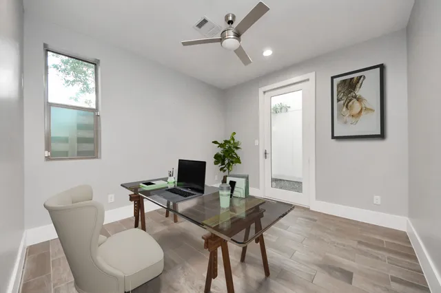 a view of a workspace with furniture and a potted plant
