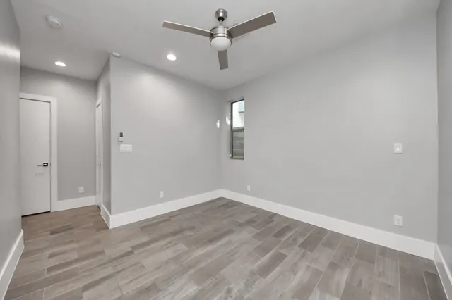 wooden floor in an empty room with a window