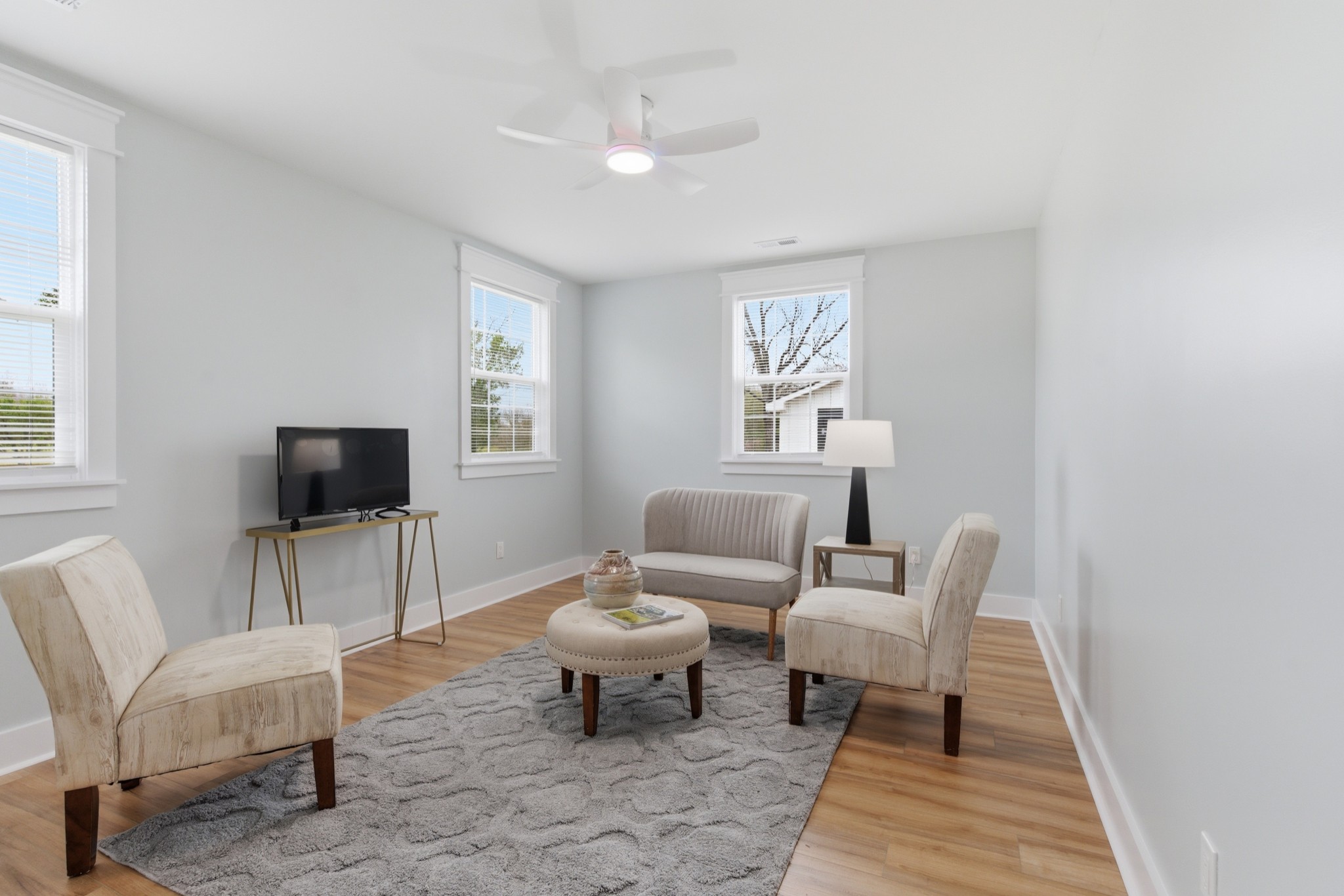 1237 Abiff Road Bon Aqua, TN 37025 - Photo 27 of 37 a living room with furniture a rug and a flat screen tv