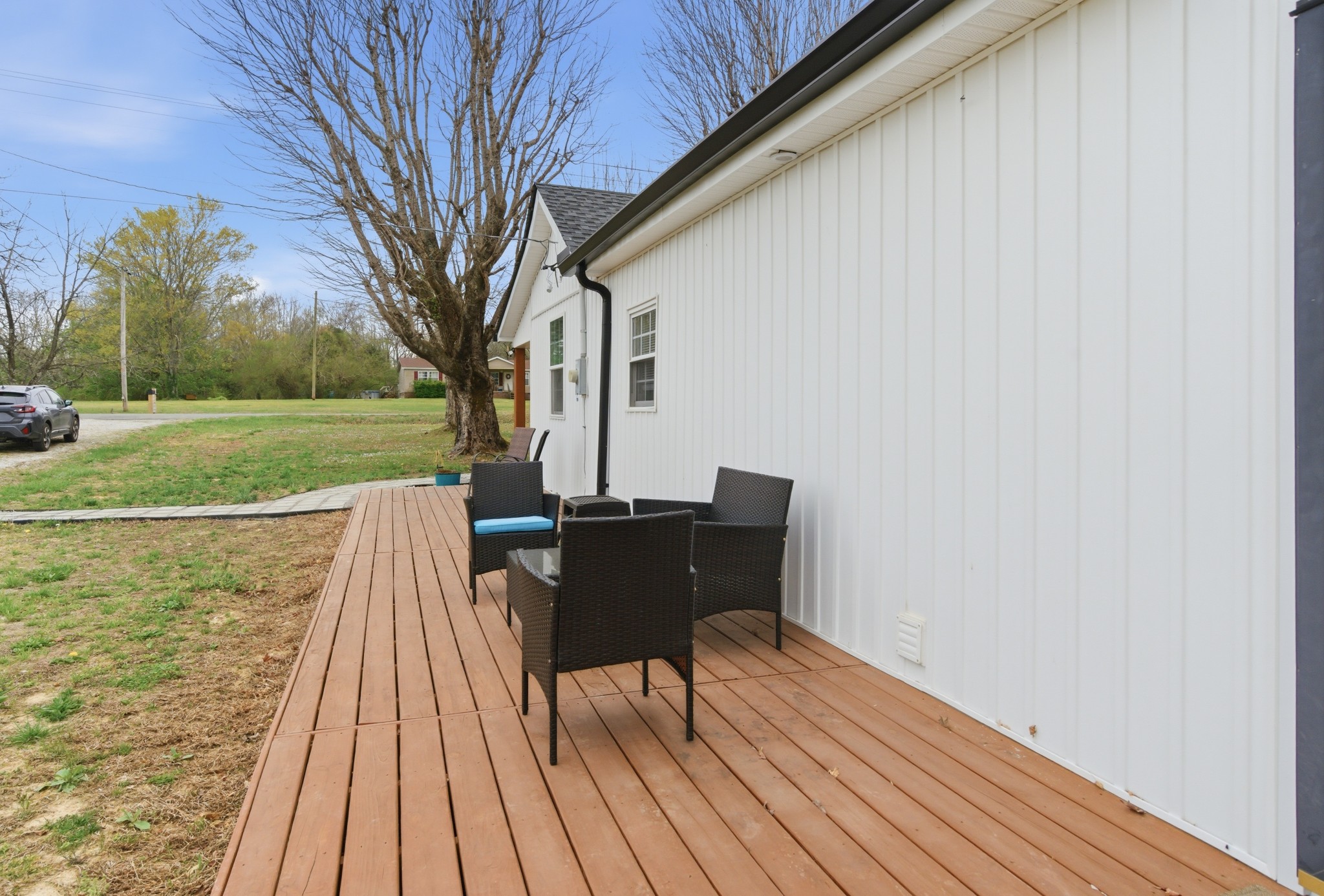 1237 Abiff Road Bon Aqua, TN 37025 - Photo 31 of 37 a view of a roof deck with table and chairs and wooden floor