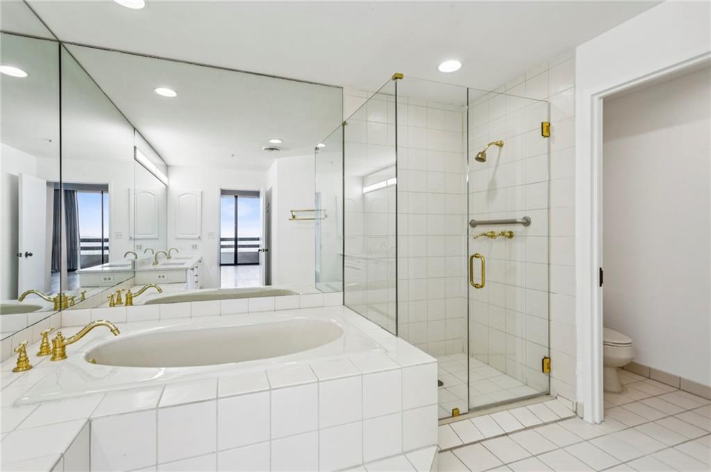 2660 Peachtree Road Northwest, Unit 32C Atlanta, GA 30305 - Photo 15 of 55 a bathroom with a tub a sink and a shower