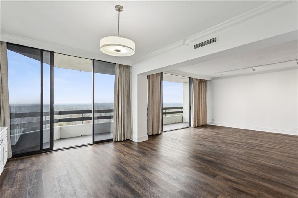 2660 Peachtree Road Northwest, Unit 32C Atlanta, GA 30305 - Photo 9 of 55 an empty room with wooden floor closet and windows