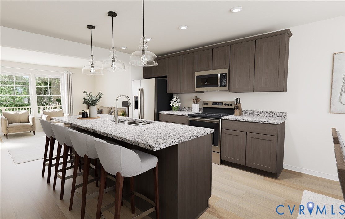 282 Greenpark Road Sandston, VA 23150 - Photo 9 of 29 a kitchen with a table chairs microwave and cabinets