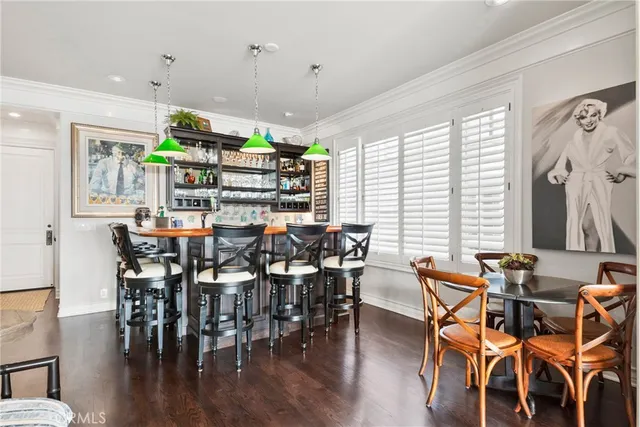a spacious bedroom with a bed and wooden floor