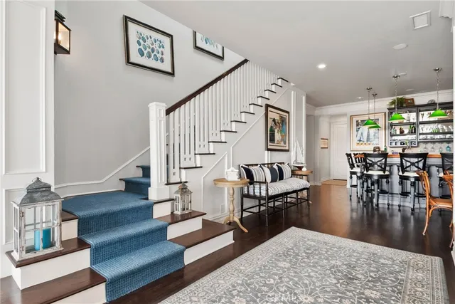 a view of a big room with wooden floor and windows