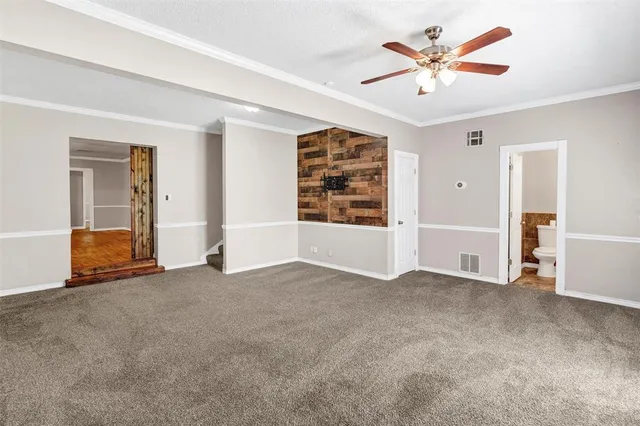 an empty room with closet and windows