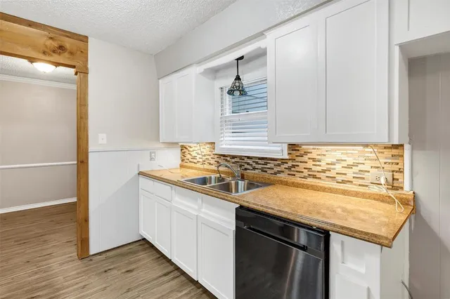 a kitchen with a sink and cabinets