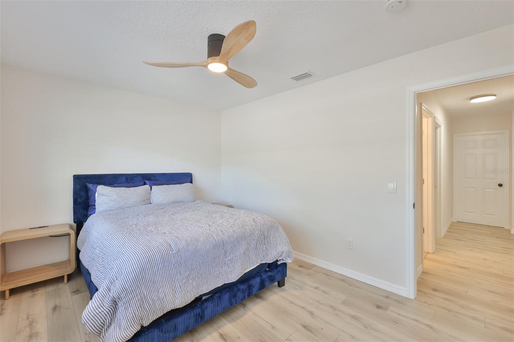 1578 Indian Bay Road Spring Hill, FL 34607 - Photo 30 of 51 a bedroom with a bed and a chandelier