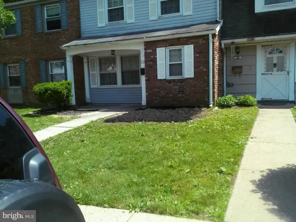 a view of a brick house with a yard