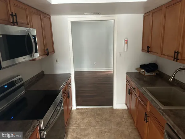 a kitchen with a stove microwave and sink