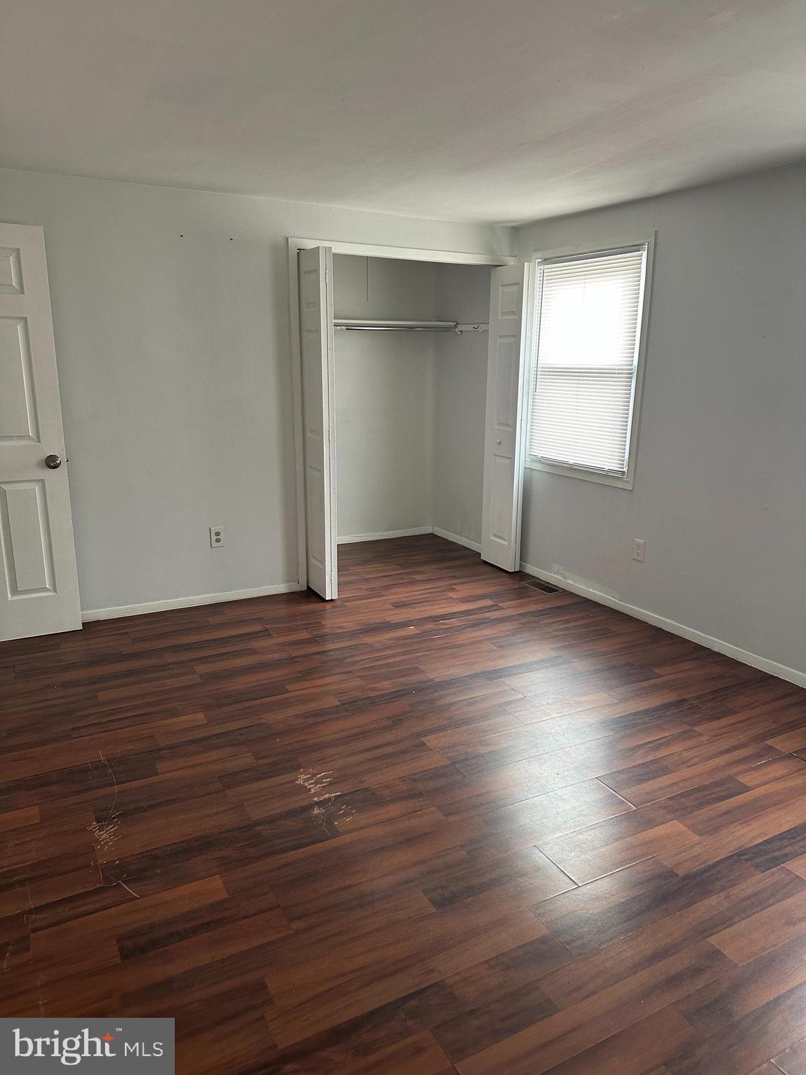 22 Roxborough Place Willingboro, NJ 08046 - Photo 8 of 14 an empty room with wooden floor and windows