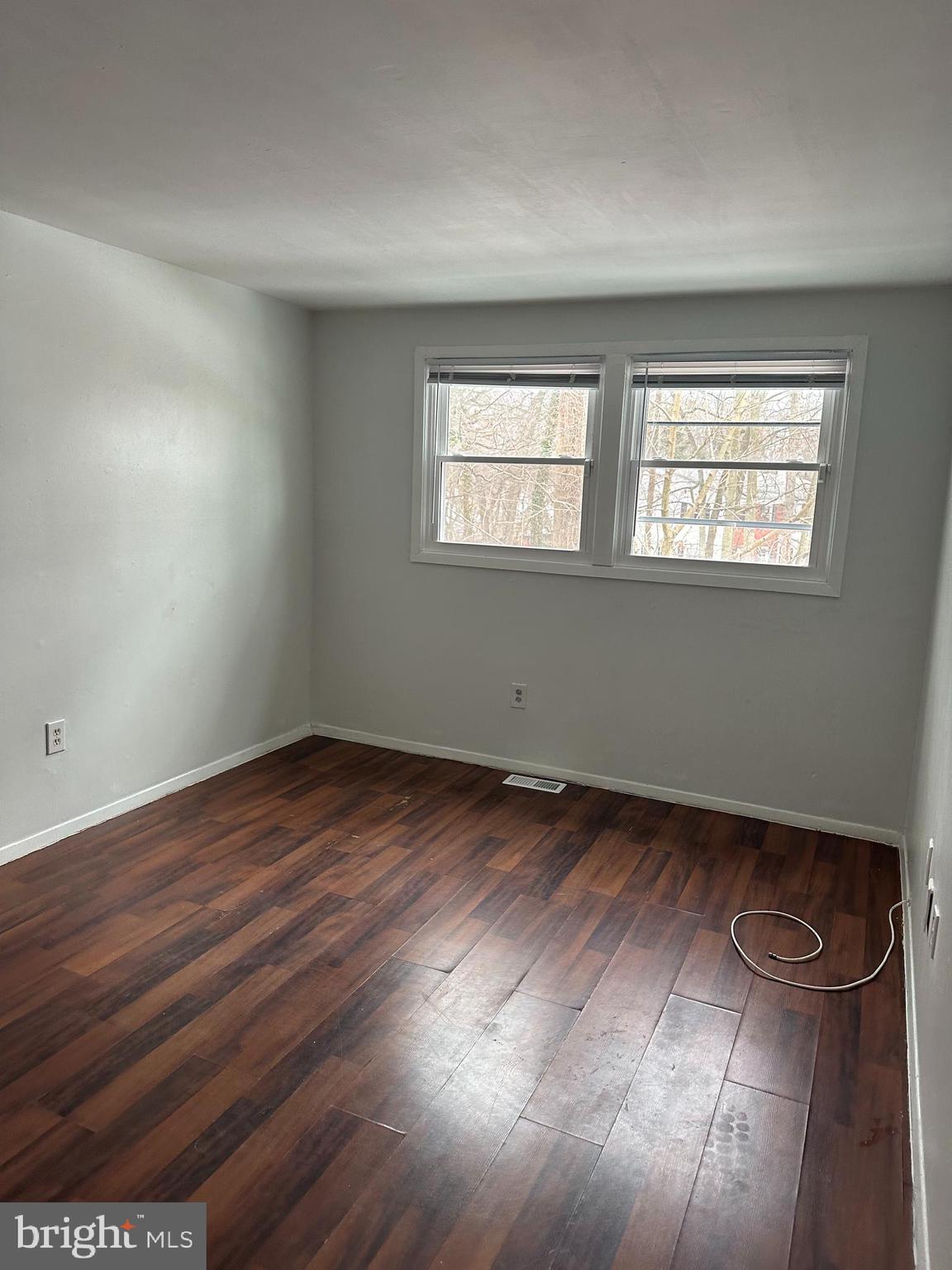 22 Roxborough Place Willingboro, NJ 08046 - Photo 9 of 14 an empty room with wooden floor and windows