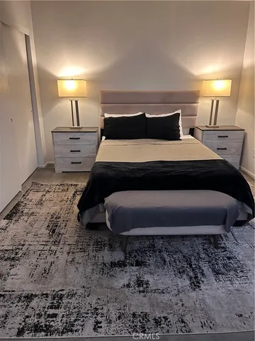 a bathroom with a granite countertop sink and a toilet