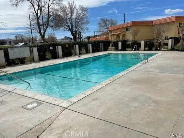 a view of a white house with a big yard and large trees